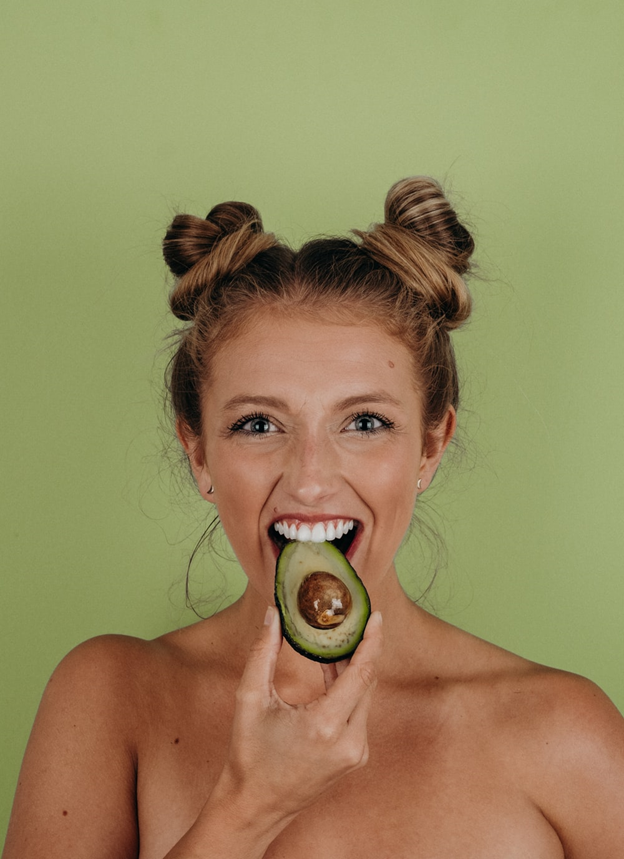 A woman tasting Avocado fruit
